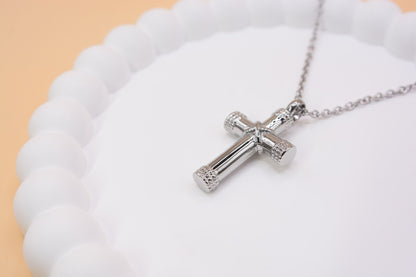 A silver coloured stainless steel cross pendant, ideal for any gender. It can be self-filled with cremation ashes or sand from a loved ones favourite beach